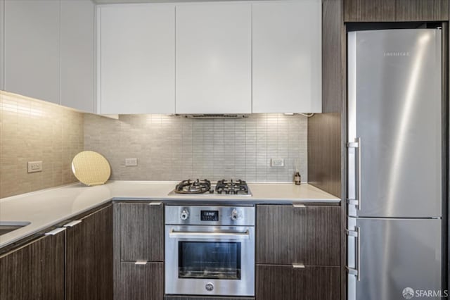 kitchen with stainless steel appliances, modern cabinets, and light countertops