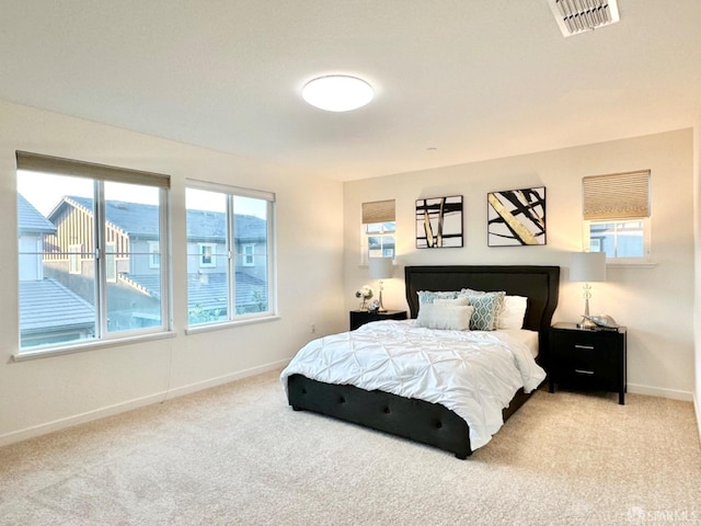 carpeted bedroom featuring multiple windows