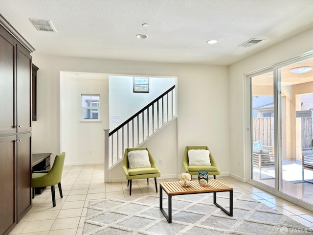 sitting room featuring a textured ceiling and light tile patterned floors