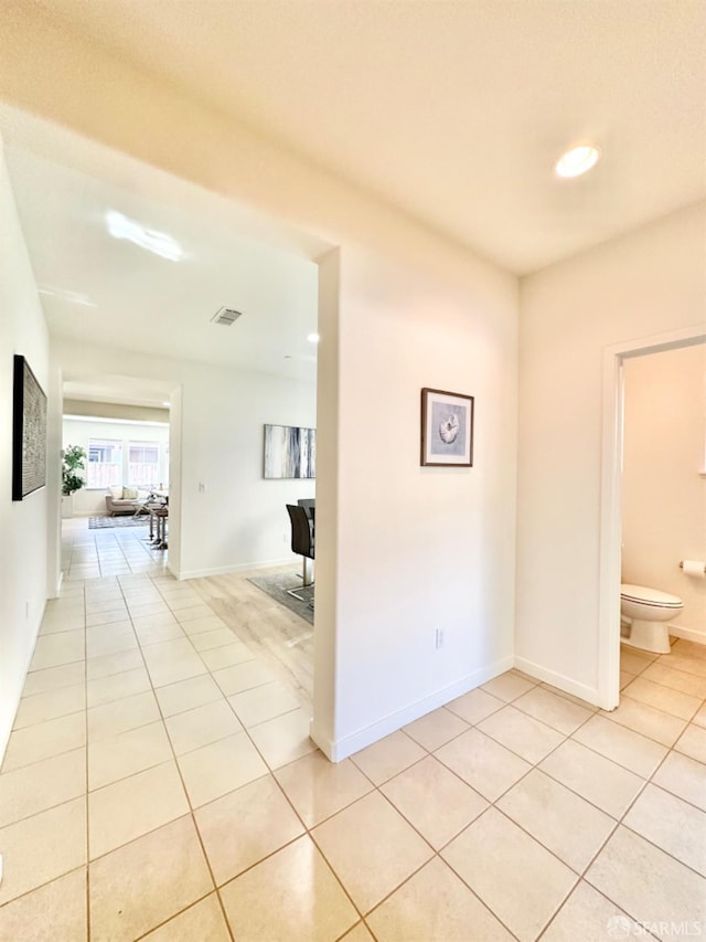 corridor with light tile patterned flooring