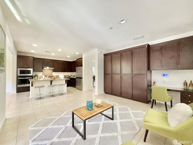 living room with built in desk and light tile patterned floors