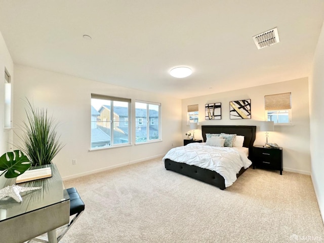 bedroom featuring light carpet