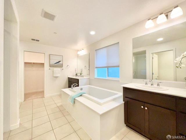 bathroom featuring vanity, independent shower and bath, and tile patterned flooring