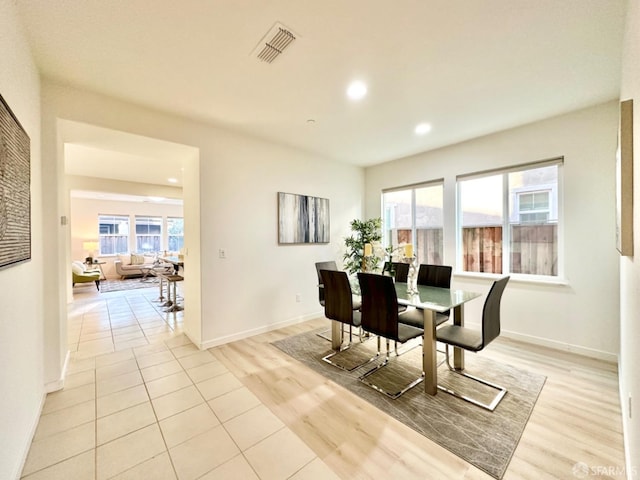 dining space featuring light hardwood / wood-style floors and a healthy amount of sunlight