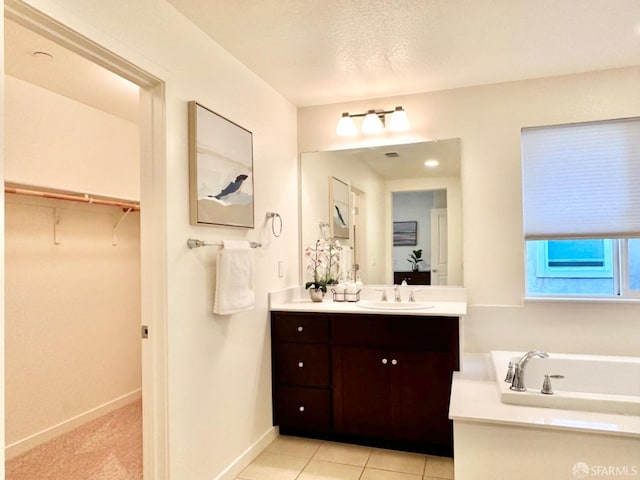 bathroom featuring vanity, tile patterned floors, and a textured ceiling