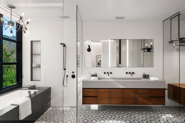 bathroom featuring walk in shower, vanity, and tile patterned flooring