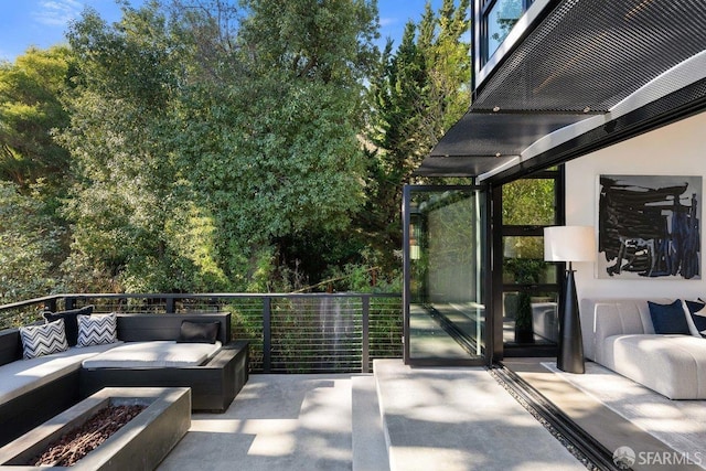 view of patio featuring an outdoor living space with a fire pit