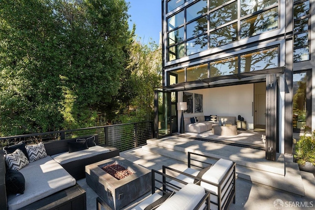 view of patio / terrace featuring an outdoor living space with a fire pit