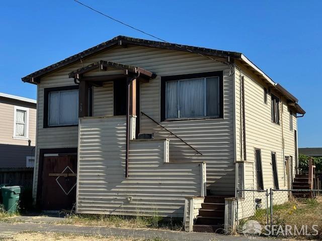 view of front of house with entry steps and fence