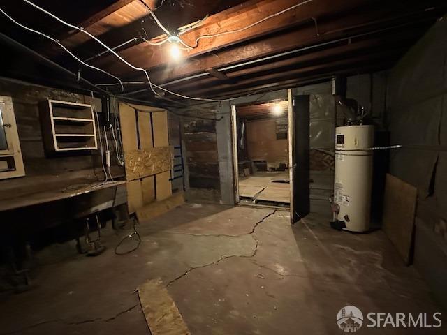 unfinished basement featuring gas water heater