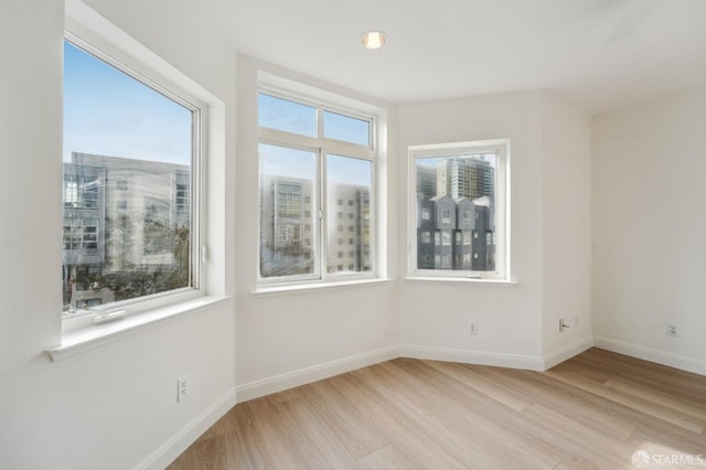 spare room with light hardwood / wood-style flooring