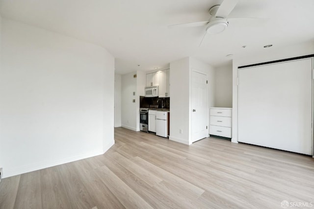 unfurnished living room with light wood-type flooring and ceiling fan