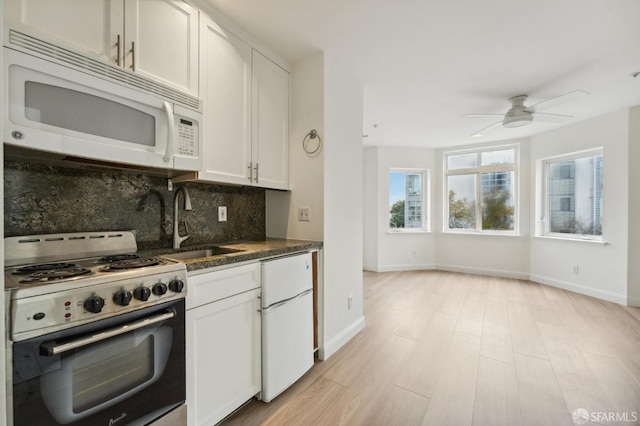 kitchen featuring ceiling fan, sink, backsplash, white appliances, and white cabinets