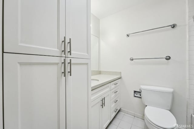 bathroom with tile patterned flooring, vanity, and toilet