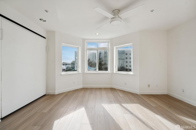 unfurnished bedroom featuring light wood-type flooring and ceiling fan