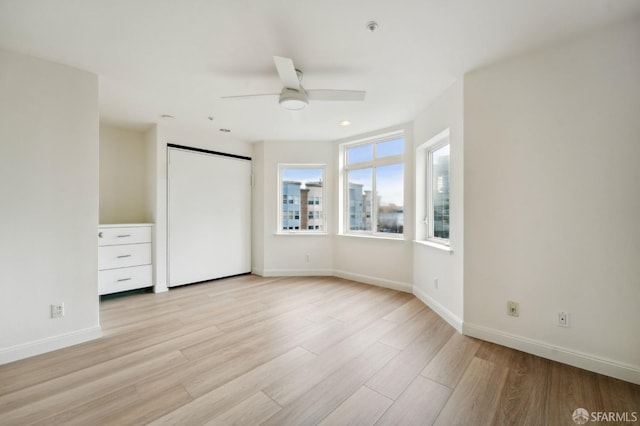 unfurnished bedroom featuring ceiling fan and light hardwood / wood-style flooring