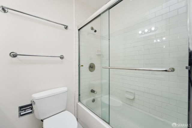 bathroom with toilet and enclosed tub / shower combo