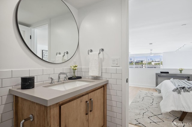 bathroom with vanity and tile walls