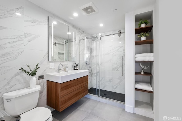 bathroom with an enclosed shower, vanity, tile walls, and toilet