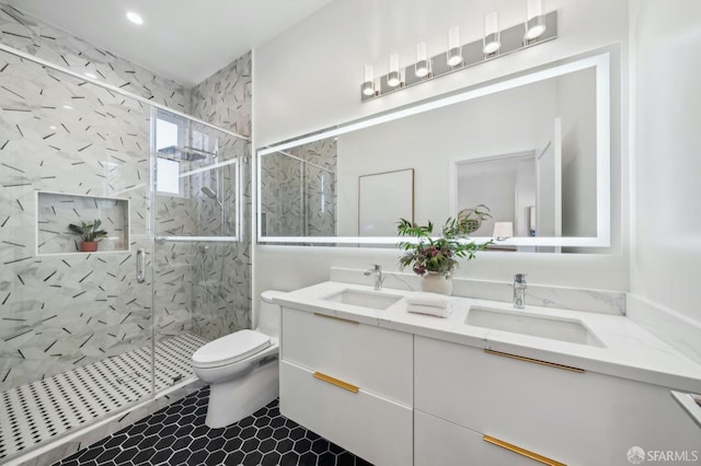 bathroom with a shower with door, vanity, and toilet