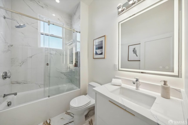 full bathroom with vanity, toilet, and combined bath / shower with glass door