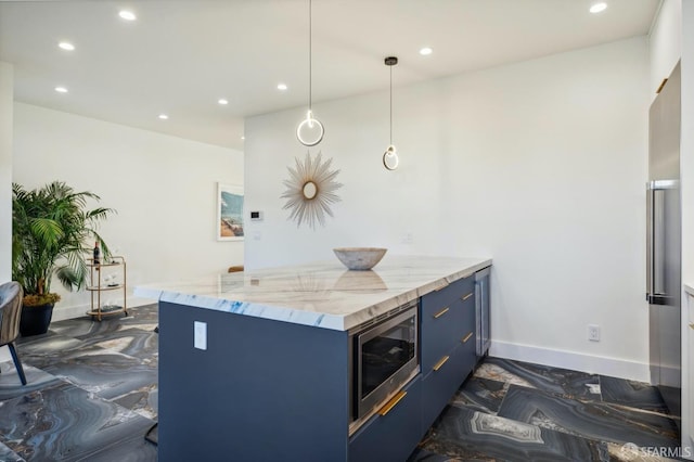 kitchen with blue cabinets, light stone counters, hanging light fixtures, stainless steel microwave, and a kitchen breakfast bar