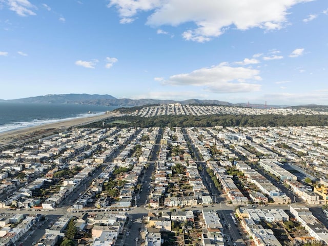 bird's eye view featuring a view of the beach and a water and mountain view