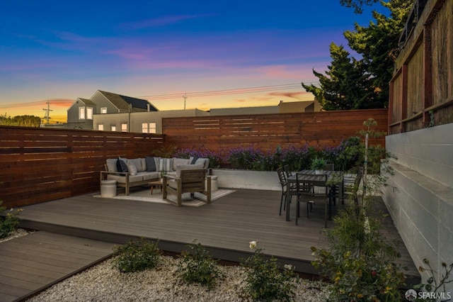 deck at dusk with an outdoor hangout area