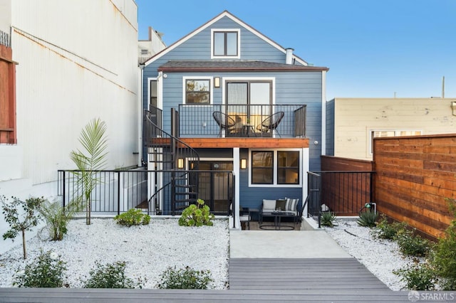 rear view of house featuring an outdoor hangout area and a balcony