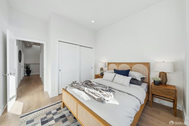 bedroom featuring a closet and light wood-type flooring