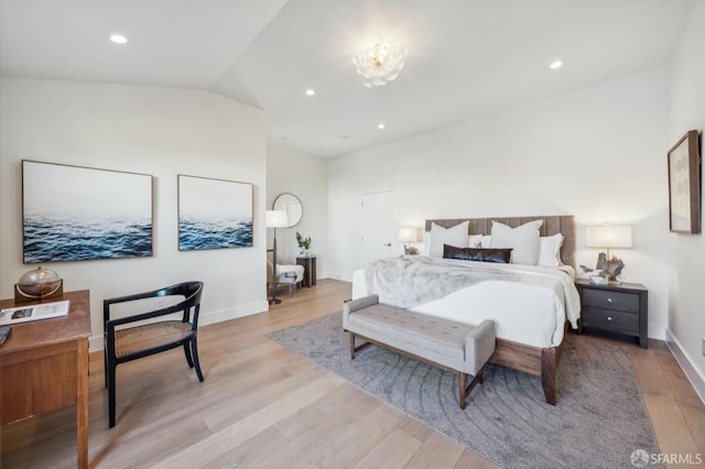 bedroom with a notable chandelier and light hardwood / wood-style flooring