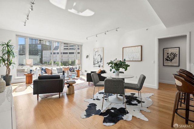 77 Van Ness Ave Unit 405, San Francisco, CA 94102 - dining space featuring rail lighting, light wood-style flooring, and baseboards