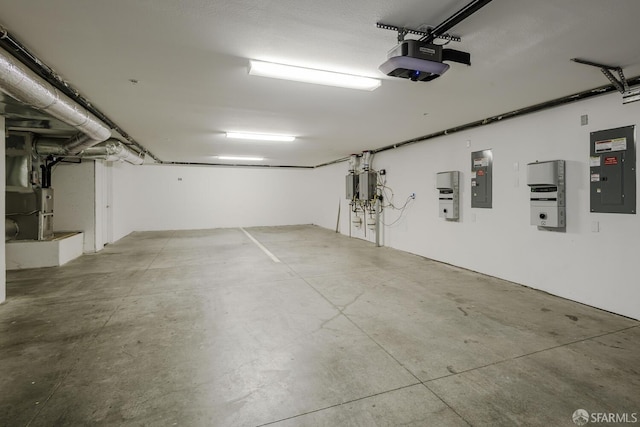 garage featuring a garage door opener, electric panel, heating unit, and water heater