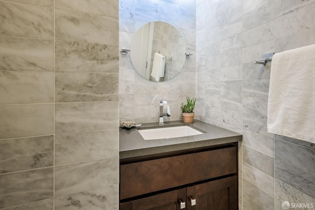 bathroom featuring tile walls and vanity