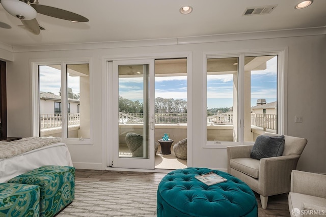 interior space featuring a ceiling fan, wood finished floors, visible vents, and recessed lighting