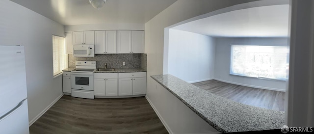 1646 19th Ave, San Francisco, CA 94122 - kitchen featuring white appliances, dark wood-style floors, white cabinetry, backsplash, and light stone counters
