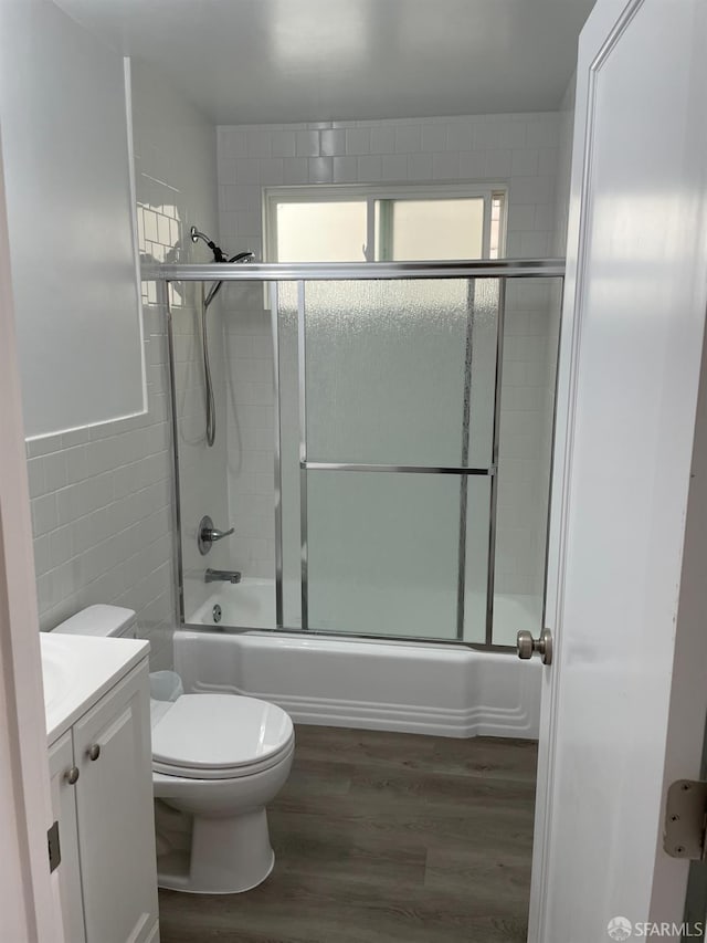 1646 19th Ave, San Francisco, CA 94122 - bathroom with vanity, wood finished floors, tile walls, and enclosed tub / shower combo