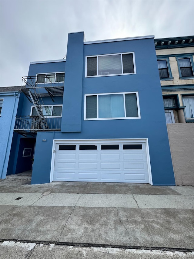 1646 19th Ave, San Francisco, CA 94122 - view of front facade featuring an attached garage, concrete driveway, and stucco siding