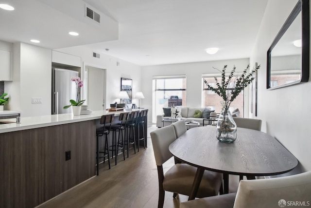 dining area featuring dark wood-type flooring