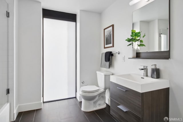 bathroom with toilet, vanity, and walk in shower