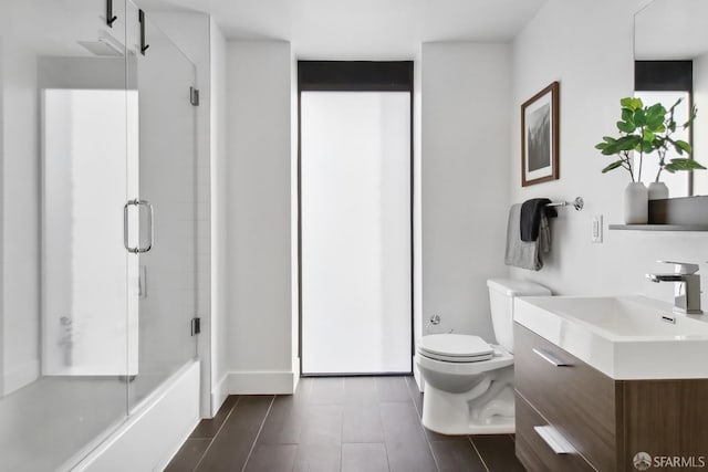 bathroom featuring an enclosed shower, vanity, toilet, and wood-type flooring