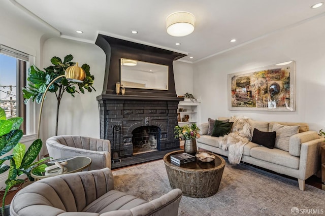 living room with a fireplace, crown molding, and recessed lighting