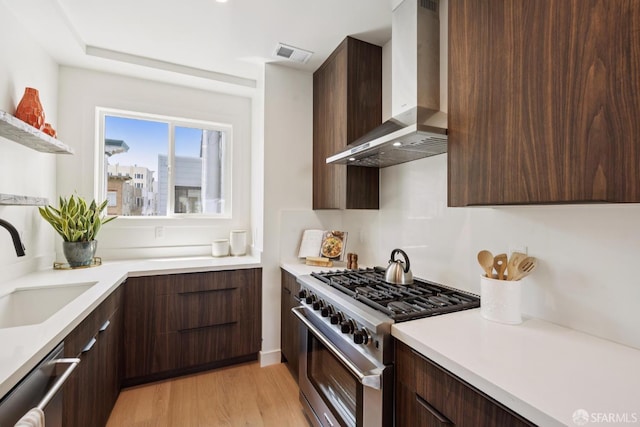 1234 Francisco St Unit 6, San Francisco, CA 94123 - kitchen featuring appliances with stainless steel finishes, wall chimney exhaust hood, modern cabinets, and dark brown cabinetry
