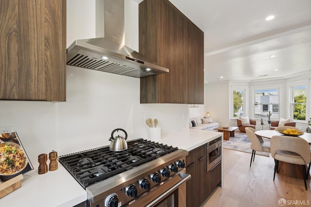 1234 Francisco St Unit 6, San Francisco, CA 94123 - kitchen featuring range hood, high end stove, modern cabinets, light countertops, and light wood-style flooring