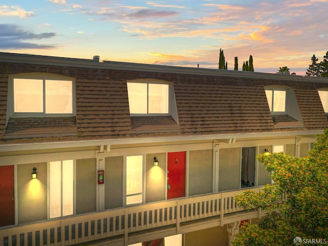 view of front of house featuring mansard roof