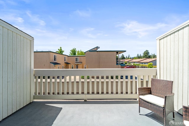 view of patio featuring a balcony and a residential view