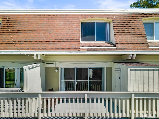 view of side of property featuring roof with shingles