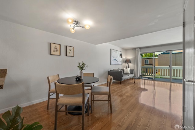 dining area with wood finished floors and baseboards