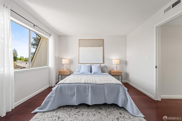 bedroom featuring wood finished floors and baseboards
