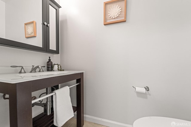 bathroom with baseboards and toilet